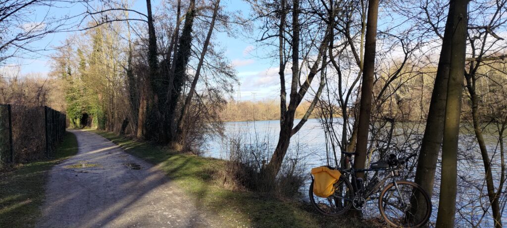 Un vélo posé sur un arbre en bord de rivière