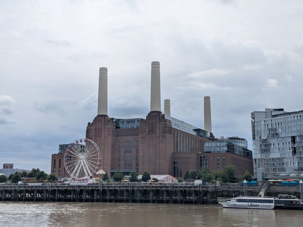 Vue de Battersea, un grand bâtiment industriel en brique rouge avec quatre grandes cheminées blanches